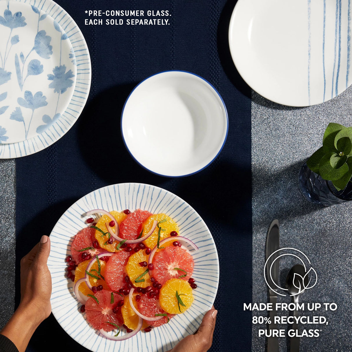 Botanical Stripes Dinnerware on tabletop with text made from up to 80% recycled pure glass