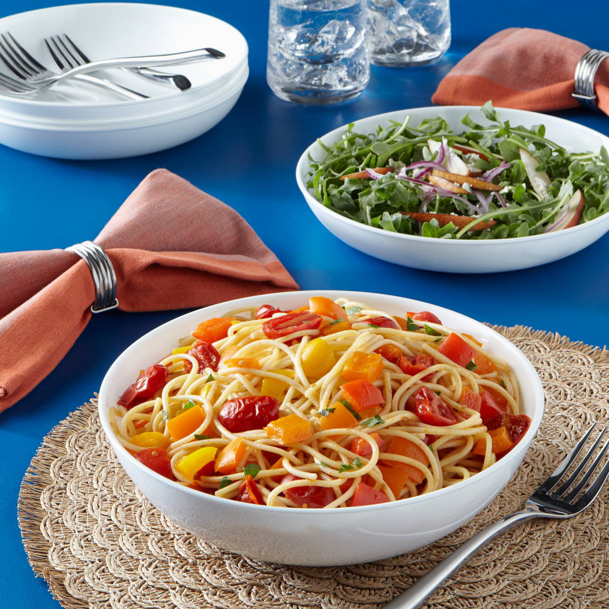 pasta with tomatoes in bowl on table
