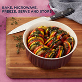  French Colors 1.5-quart Round Baking Dish, Cabernet with food inside and text on photo bake, microwave, freeze, serve &amp; store